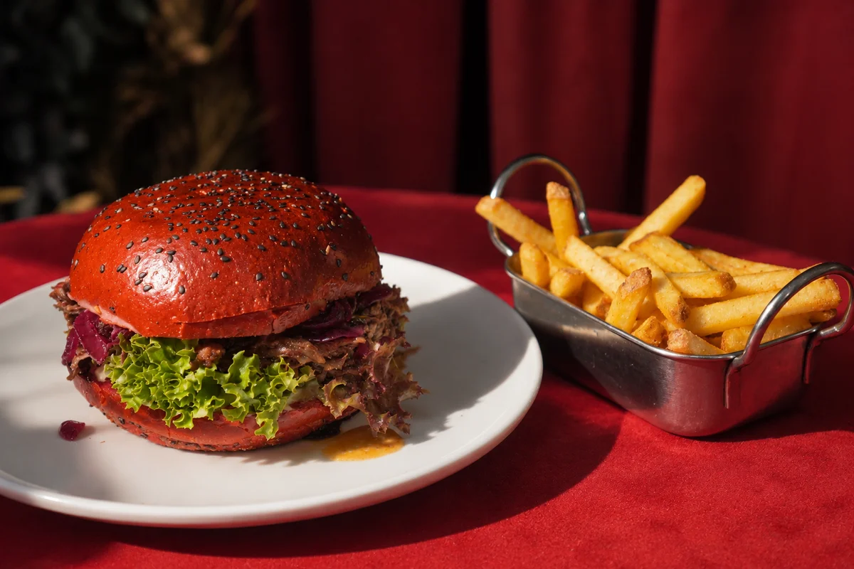 Burger in a red bun with fries